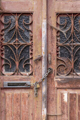 Chain and padlock on an old wooden door.