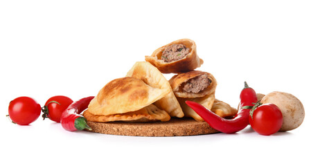 Cork stand with tasty meat empanadas and vegetables on white background