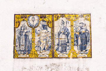 Traditional hand painted azulejos tiles depicting Madonna and Child, and saints Sebastian, Marsal, and Antonio.