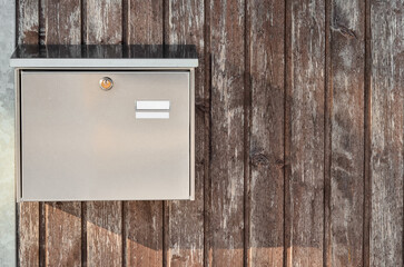 View of mailbox on wooden fence outdoors, closeup