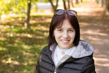 A beautiful teenage girl is cheerful and happy walking in park, she recently reconciled with her...
