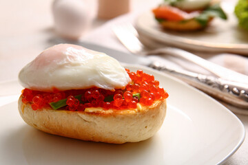 Plate with delicious egg Benedict on table, closeup