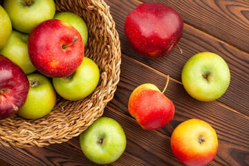 colorful apples on wood background