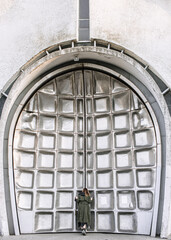 Metal textured doors of a futuristic concrete building. Futuristic architecture.