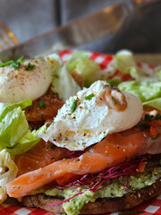 Sandwich with salmon and egg. Avocado with poached egg and salted salmon