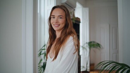 Happy girl walking at morning flat closeup. Smiling woman spinning at cozy house