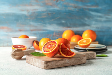 Board with slices of juicy blood orange fruit on white table