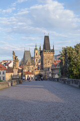 Fototapeta na wymiar Beautiful view of the Malostranska tower of Charles Bridge at dawn in Prague, Czech Republic