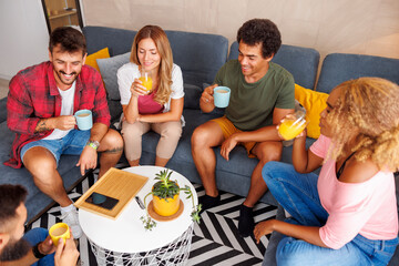 Friends drinking coffee and having fun at home