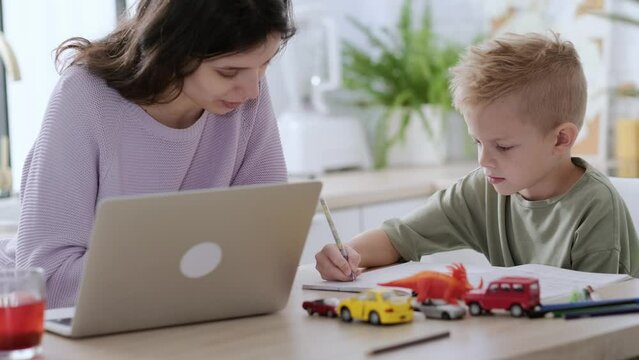 Work from home and family education, Mom and son using remote access technology for learning and work, woman works on laptop, child writes in textbook