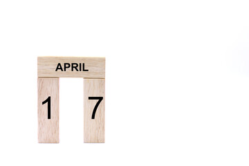 April 17 displayed wooden letter blocks on white background with space for print. Concept for calendar, reminder, date. 