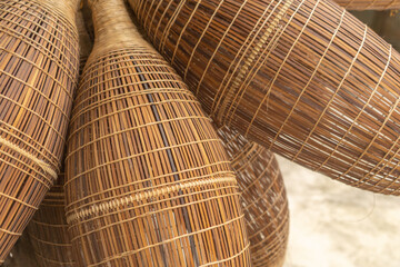 Weaving bamboo fish trap with basket in Hanoi, Vietnam.