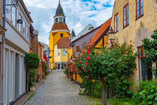 Yellow clock tower at the end of the street in Faaborg, Denmark