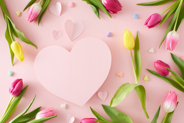 Obraz na płótnie Canvas Mother's Day celebration concept. Creative layout made of pink origami paper hearts colorful tulips and hearts baubles on isolated pastel pink background. Flat lay blank space