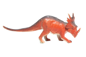 An isolated worn toy dinosaur in profile. Styracosaurus.