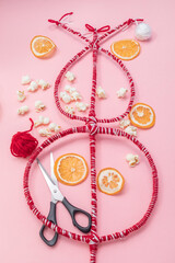 Flatly Survakane, Survachka, Surva On Pink Background. Bulgarian Traditional Cornel Stick With Decorations, Dried Fruits, Threads, Popcorn. Christmas Entertainment. Vertical Plane
