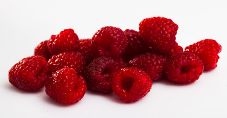 Close up of ripe red raspberries on white surface, nobody