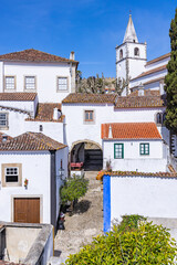 Small church steeple and homes in Obidos.