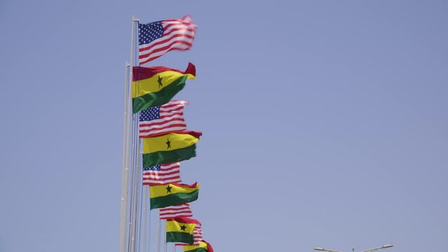 American Vice President Kamala Harris on a tour of Ghana, Zambia and Tanzania. People holding flags. Ghana flags. American flags
