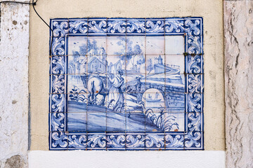 Traditional blue and white azulejos tile mural on a building in Lisbon.