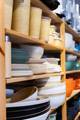 Obraz na płótnie Canvas Shelves with assorted dishware at household goods store
