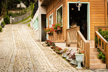 Rustic wooden house next to a stone tiled ramp.