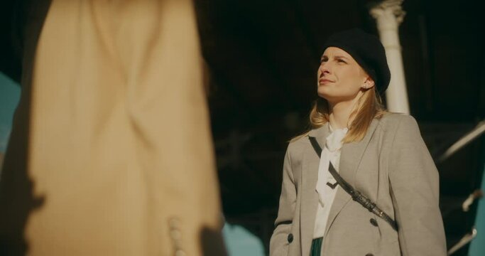 Two Women Talking at Railway Station