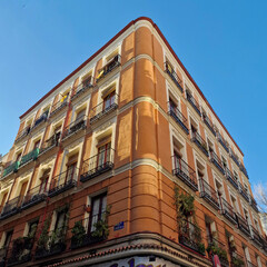 A fragment of an interesting tenement house in the center of Madrid on a sunny winter day in Madrid, Madrid, Spain.
