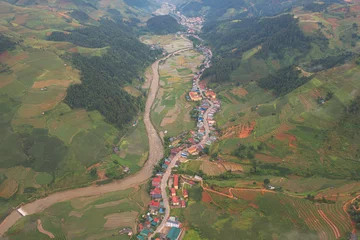 Foto op Plexiglas Mu Cang Chai Aerial top view of Mu Cang Chai City urban town with fresh paddy rice, green agricultural fields in countryside or rural area, mountain hills valley in Asia, Vietnam. Nature landscape background.