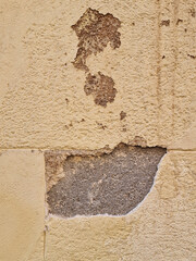 Close-up of a fragment of an old wall with peeling paint on one of the tenement houses in the Old Town of Madrid, Madrid, Spain.