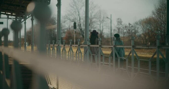 Two Women Walking at Railway Station
