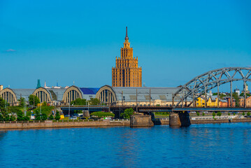view of the zeppelin hangars and the academy of sciences building next to a steel railway bridge in the Latvian capital Riga. © dudlajzov