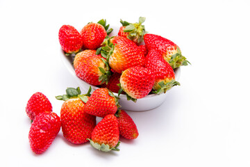 Fresh organic Strawberries piled high in a ceramic dish