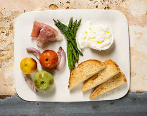 An Appetizer plate of roasted and cured food
