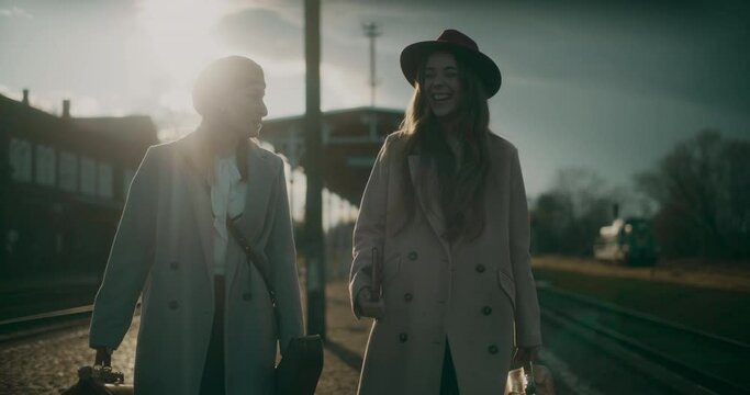 Two Women Talking at Railway Station