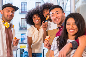 Portrait group of friends eating pizza on the terrace at home, lunch or dinner, lifestyle