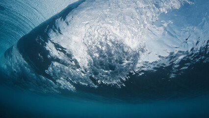 Underwater view of the ocean wave breaking on the shore in the Maldives