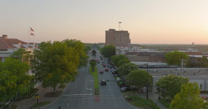 Aerial Forward Shot Of Cars Moving On Road In Residential City Against Sky During Sunset - Tuscaloosa, Alabama