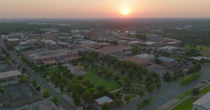 Aerial Shot Of Residential Buildings On City Landscape, Drone Ascending Backwards During Sunset - Tuscaloosa, Alabama