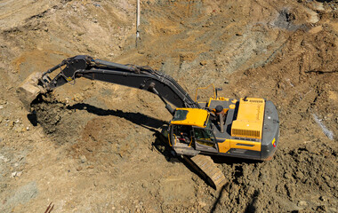 Excavator and truck working in construction