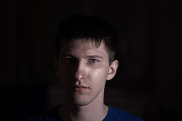 portrait of a young man on a dark background