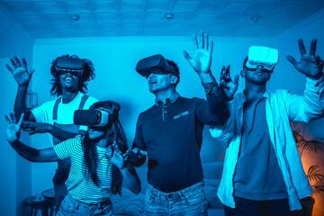 Group of young people in vr glasses in a virtual reality game in a blue light, amazed touching virtual objects, futuristic or science, technology concept