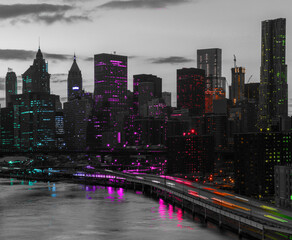 Obraz premium Rainbow colored lights shining on the black and white skyline buildings of New York City at night