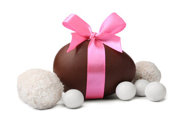 Sweet chocolate egg with pink bow and different candies isolated on white