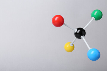 Molecular atom model on light grey background, space for text. Chemical structure