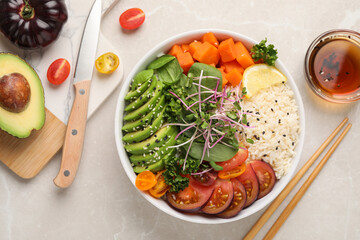 Delicious vegan bowl with avocados, carrots and tomatoes on light grey table, flat lay