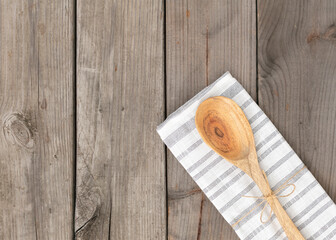 A wooden spoon on wood rustic table.