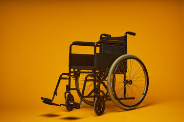 Fototapeta na wymiar Minimal concept shot of modern wheelchair of black metal against contrasted yellow background, copy space