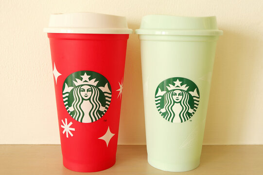 Chonburi, Thailand - February 19, 2023 : Cup of Starbucks red and green color popular holiday beverage on the table.