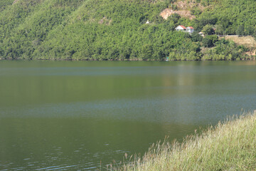 Lake beautiful landscape. Forest background and textured flowing of small waves at Kaeng Krachan National Park in Thailand.